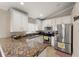 Well-lit kitchen features stainless steel appliances and granite countertops at 182 Westmoreland Cir, Kissimmee, FL 34744