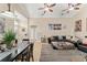 Inviting living room with tile floors, ceiling fan, dining area, and comfortable sofa at 182 Westmoreland Cir, Kissimmee, FL 34744
