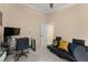 Well-lit office features a glass desk, black leather futon and gray carpet at 182 Westmoreland Cir, Kissimmee, FL 34744