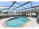 Inviting screened-in pool and spa features string lights, covered lounge, and clear blue water at 182 Westmoreland Cir, Kissimmee, FL 34744