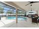 Relaxing screened-in pool and spa with custom bar for entertaining at 182 Westmoreland Cir, Kissimmee, FL 34744