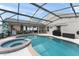 Inviting pool and spa area with screened enclosure and covered patio at 182 Westmoreland Cir, Kissimmee, FL 34744