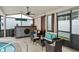 Screened-in patio with custom bar and seating overlooking the pool and spa at 182 Westmoreland Cir, Kissimmee, FL 34744
