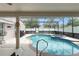 Relaxing screened-in pool and spa under string lights for ambiance at 182 Westmoreland Cir, Kissimmee, FL 34744