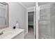 Bright bathroom featuring an enclosed shower, vanity with sink, and stylish gray tile flooring at 1836 Se 6Th Ave, Ocala, FL 34471