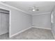 Spacious bedroom featuring a closet, gray walls, tiled flooring, and a ceiling fan at 1836 Se 6Th Ave, Ocala, FL 34471