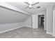 Well-lit bedroom with tiled floors, access to hallway, and a modern ceiling fan at 1836 Se 6Th Ave, Ocala, FL 34471