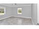 Bright bedroom featuring gray tile floors, two windows, neutral walls, and a ceiling fan at 1836 Se 6Th Ave, Ocala, FL 34471
