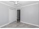Spacious bedroom featuring a closet, gray walls, tiled flooring, and a ceiling fan at 1836 Se 6Th Ave, Ocala, FL 34471