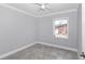 Neutral bedroom featuring gray tile flooring, a single window, neutral walls, and a ceiling fan at 1836 Se 6Th Ave, Ocala, FL 34471