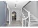 Elegant entryway with tiled floors, curved archways, and a staircase with black wrought iron at 1836 Se 6Th Ave, Ocala, FL 34471