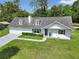 Charming home with dormer windows, gray roof, manicured lawn, and a welcoming walkway at 1836 Se 6Th Ave, Ocala, FL 34471