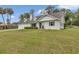 Inviting home featuring a well-kept lawn, a modern white facade, and a gray roof at 1836 Se 6Th Ave, Ocala, FL 34471