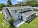 Rear exterior view of a house with gray roof, patio, and fenced in yard at 1836 Se 6Th Ave, Ocala, FL 34471