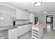 Kitchen featuring white cabinets, granite countertops, a center island, and gray tile floors at 1836 Se 6Th Ave, Ocala, FL 34471