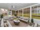 Cozy sunroom with ample seating, plants, and backyard views at 1836 Se 6Th Ave, Ocala, FL 34471