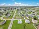 This aerial view shows a residential neighborhood with green lawns, various homes, and a network of roads at 200 Cimarron Dr, Kissimmee, FL 34759