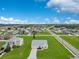 This aerial view shows a home with a long driveway and a well-manicured lawn in a suburban neighborhood at 200 Cimarron Dr, Kissimmee, FL 34759