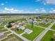 A sprawling neighborhood with homes, roads, and green spaces as seen from an aerial perspective at 200 Cimarron Dr, Kissimmee, FL 34759