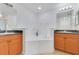 Bright bathroom features a soaking tub with dual sink vanity and decorative accents at 200 Cimarron Dr, Kissimmee, FL 34759