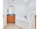 Bathroom featuring a corner bathtub, vanity with sink, and a tiled floor at 200 Cimarron Dr, Kissimmee, FL 34759