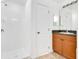 Tiled walk-in shower with a wooden vanity and light fixtures at 200 Cimarron Dr, Kissimmee, FL 34759