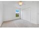 Bedroom features carpet, a ceiling fan, a window with exterior views and a closet at 200 Cimarron Dr, Kissimmee, FL 34759