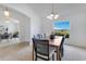 Light-filled dining room featuring a chandelier and a backyard view through a large window at 200 Cimarron Dr, Kissimmee, FL 34759
