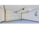 Spacious two car garage with gray epoxy flooring and an automatic garage door opener at 200 Cimarron Dr, Kissimmee, FL 34759