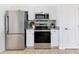 Bright kitchen features stainless steel appliances, white cabinetry, and modern finishes at 200 Cimarron Dr, Kissimmee, FL 34759