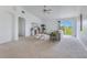 Bright living room offers a neutral color palette, high ceilings and sliding glass door to yard at 200 Cimarron Dr, Kissimmee, FL 34759