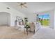 Bright living room with neutral walls and carpet, featuring a comfortable sofa and sliding glass doors to the backyard at 200 Cimarron Dr, Kissimmee, FL 34759