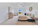 Beautifully lit main bedroom featuring ceiling fan, neutral colors, and tasteful decor at 200 Cimarron Dr, Kissimmee, FL 34759
