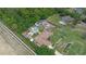 Aerial view of a cozy property with mature trees, a backyard pool, storage units, and a well-kept lawn at 2112 Plymouth Sorrento Rd, Apopka, FL 32712