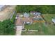 An aerial view of the property featuring a pool, backyard buildings, mature trees, and a well-kept lawn at 2112 Plymouth Sorrento Rd, Apopka, FL 32712