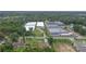 Aerial view of the residential property with a well-maintained lawn near rows of tree greenhouses in the neighborhood at 2112 Plymouth Sorrento Rd, Apopka, FL 32712