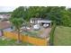 Aerial view of the property's backyard featuring a boat, trailer, storage, a fence, and mature tropical trees at 2112 Plymouth Sorrento Rd, Apopka, FL 32712