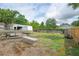 Backyard featuring a trailer, boat, and a partially open garage at 2112 Plymouth Sorrento Rd, Apopka, FL 32712