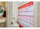 This bathroom features a toilet, shower, floral shower curtain, and doorway to the vanity at 2112 Plymouth Sorrento Rd, Apopka, FL 32712