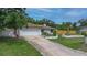 Home exterior with a driveway, lush lawn, and garden at 2112 Plymouth Sorrento Rd, Apopka, FL 32712