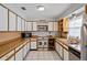 Bright kitchen with white cabinets, stainless steel appliances, and tile flooring at 2112 Plymouth Sorrento Rd, Apopka, FL 32712