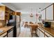 An open-concept kitchen with bright white cabinetry and a stainless steel refrigerator at 2112 Plymouth Sorrento Rd, Apopka, FL 32712