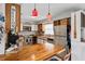 Well-lit kitchen with butcher block island, white cabinetry, and stainless steel appliances at 2112 Plymouth Sorrento Rd, Apopka, FL 32712