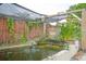 Lush backyard featuring a serene Koi pond with waterfall feature and decorative foliage at 2112 Plymouth Sorrento Rd, Apopka, FL 32712