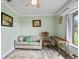 Cozy green living room with a comfortable sofa, hardwood floors, and natural light at 2112 Plymouth Sorrento Rd, Apopka, FL 32712