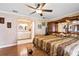 Comfortable main bedroom with hardwood floors, a ceiling fan, and an ensuite bathroom at 2112 Plymouth Sorrento Rd, Apopka, FL 32712