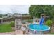 Above-ground pool with a slide and ladder in a backyard setting with a patio and garden at 2112 Plymouth Sorrento Rd, Apopka, FL 32712