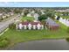 Aerial view of a multi-Gathering building near a tranquil lake, showcasing the community's setting at 214 Majors Ln # B, Kissimmee, FL 34743