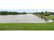 Backyard with a view of the lake with trees and green grass at 214 Majors Ln # B, Kissimmee, FL 34743