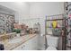 Bathroom featuring a vanity and a shower with floral curtains and a rack above the toilet at 214 Majors Ln # B, Kissimmee, FL 34743